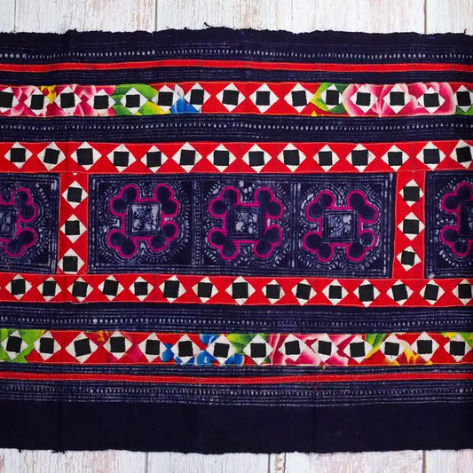 Vindigo black fabric roll with multicolor hand embroidery flat view