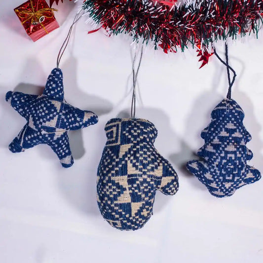 Vindigo blue tribal embroidered star, mitten, and tree ornaments hanging under garland