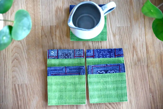 Teapot placed on green hemp coaster with blue indigo border