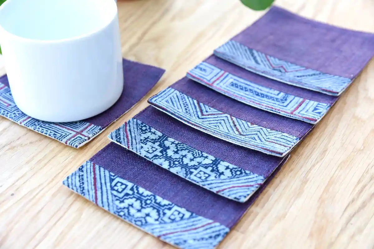 Styled arrangement of indigo hemp coasters with cup on table