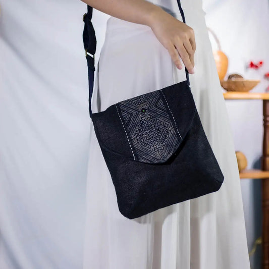Black hemp crossbody bag with H’Mong patch, worn across the body by model