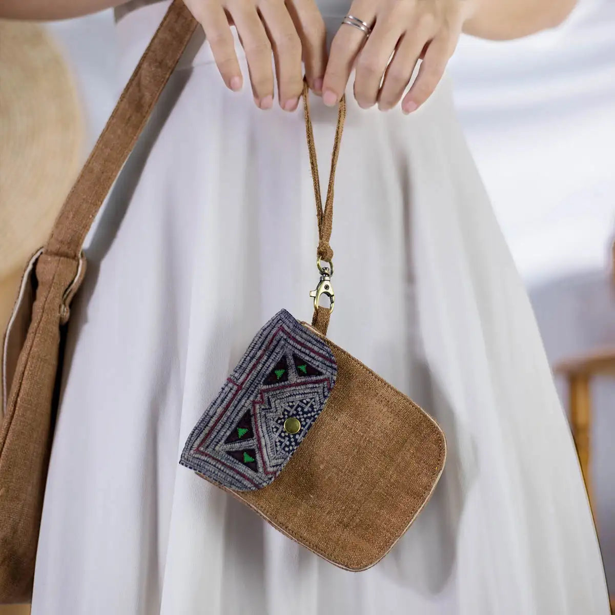 Side view of model with brown hemp flip phone belt bag and vintage patch.