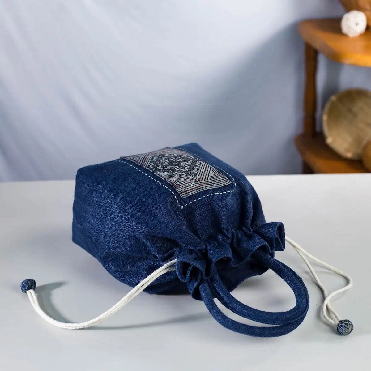 Top view of indigo hemp bucket bag with drawstring closure, eco-friendly and handmade craftsmanship.