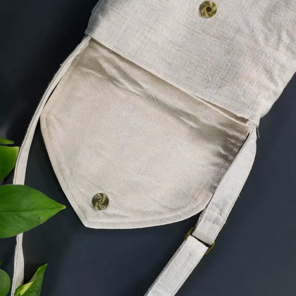 Open view of natural hemp handbag with bamboo handle and button closure