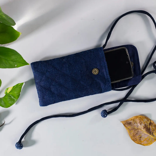Closed view of indigo hemp mobilväska phone bag with strap and H’mong patch, sustainable design.