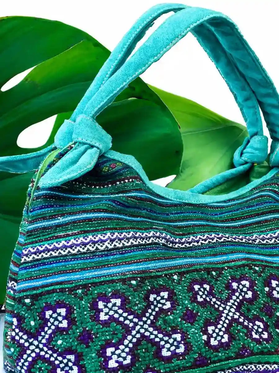 Vindigo handbag teal embroidered with green lining side detail view