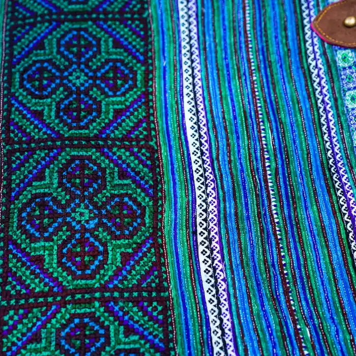 Fabric close-up showing blue-green woven tribal lines