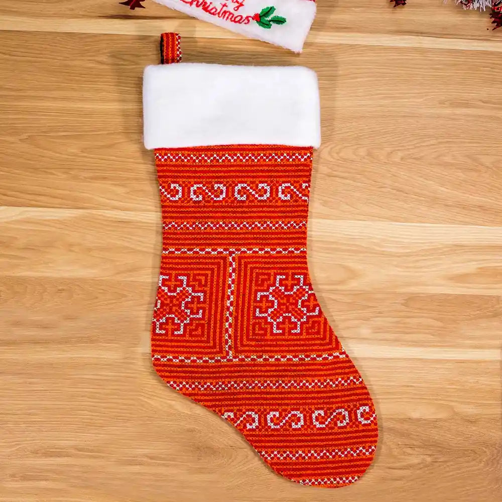 Red and white Nordic stocking photographed on wood floor