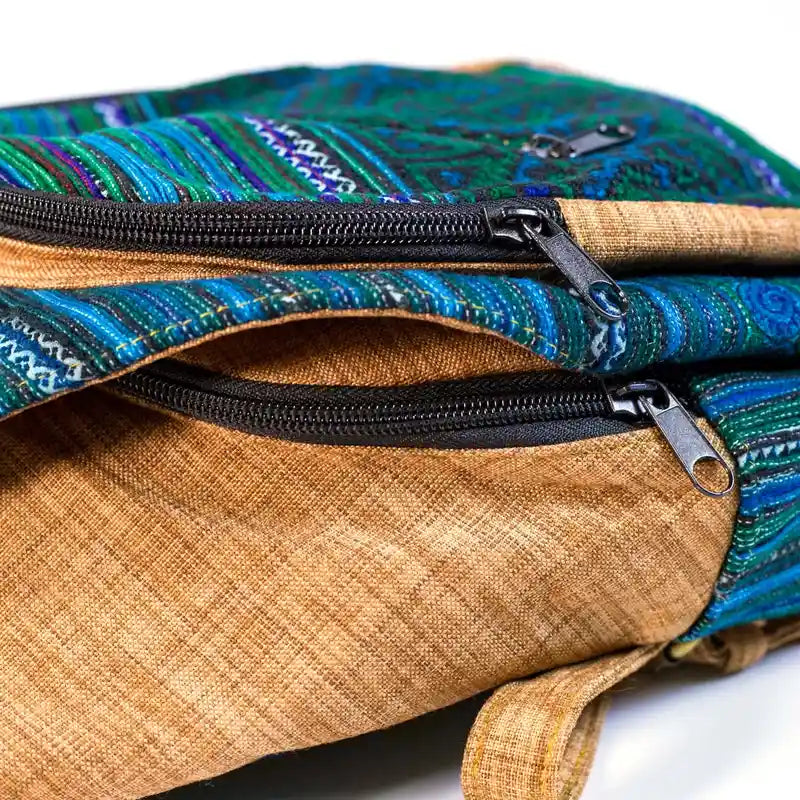 Vindigo close-up of zipper and flap hook on embroidered cotton backpack