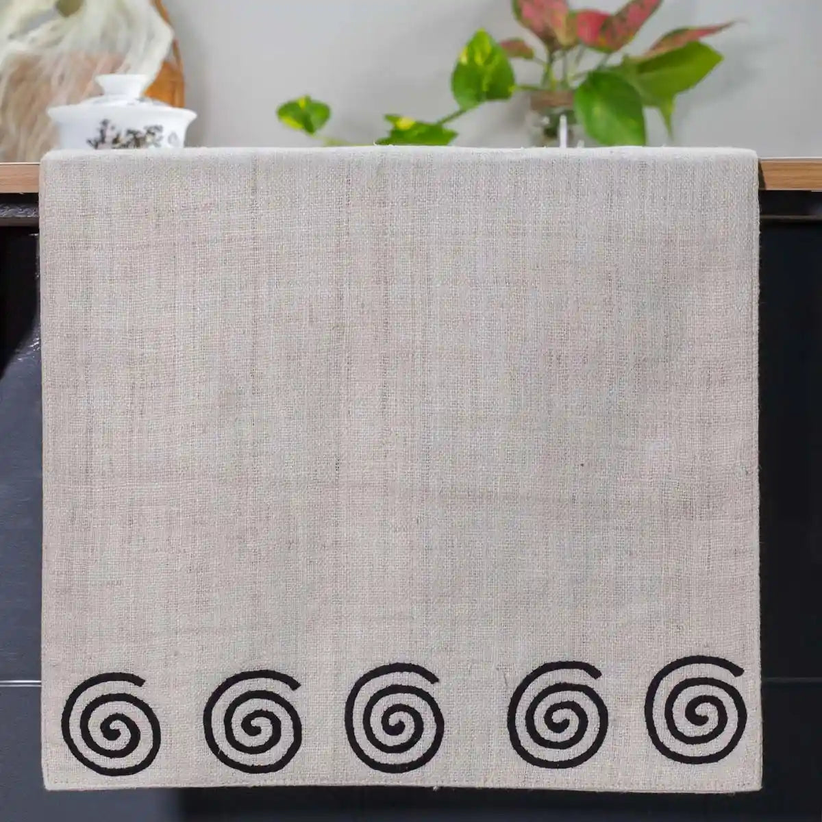 Vindigo beige hemp table runner end view with alternating spiral embroidery design