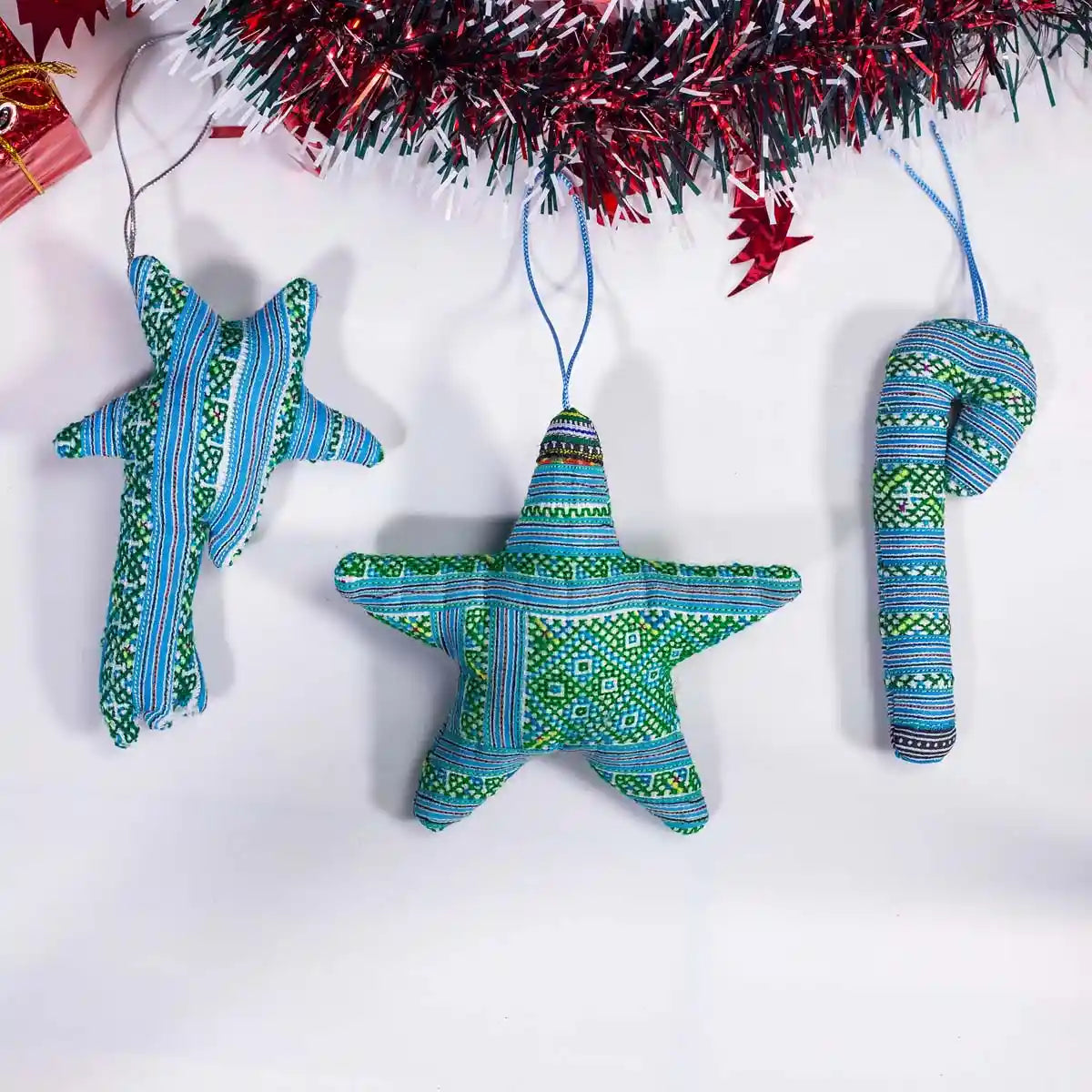 Vindigo green tribal embroidered Christmas ornaments hanging under garland
