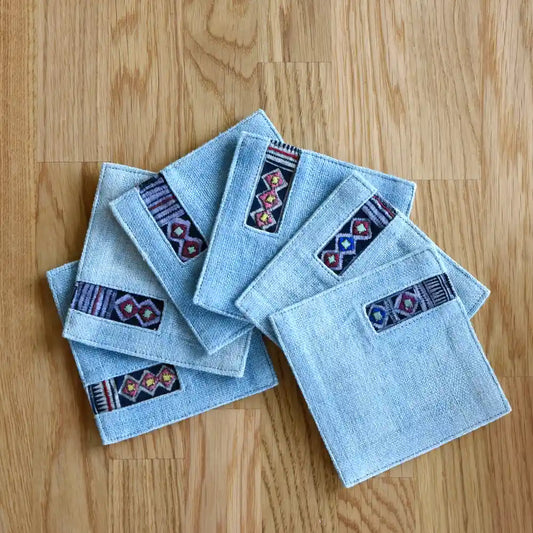 Set of light denim coasters with handmade tribal embroidered trim