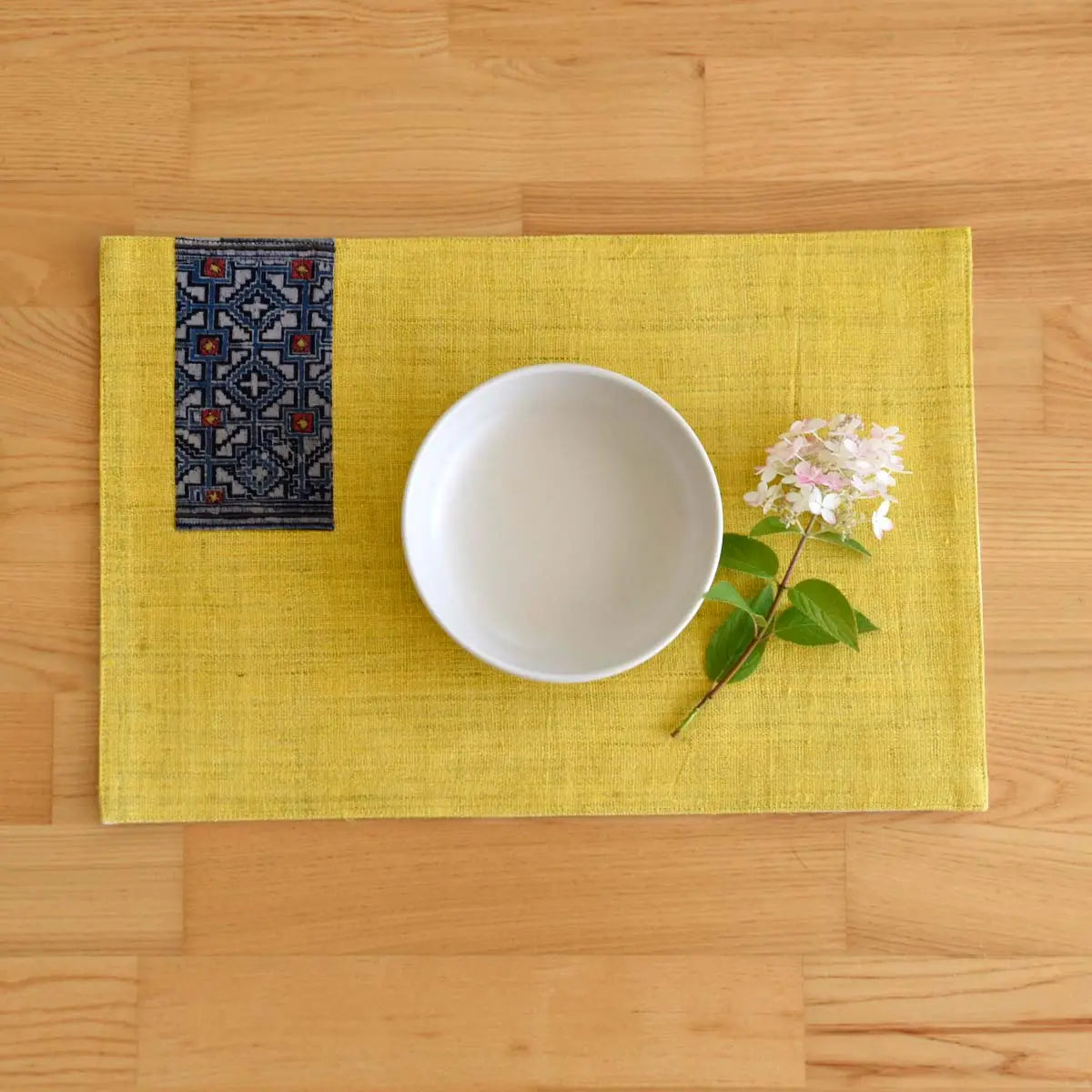 Vindigo yellow hemp placemat with indigo napkin and white bowl