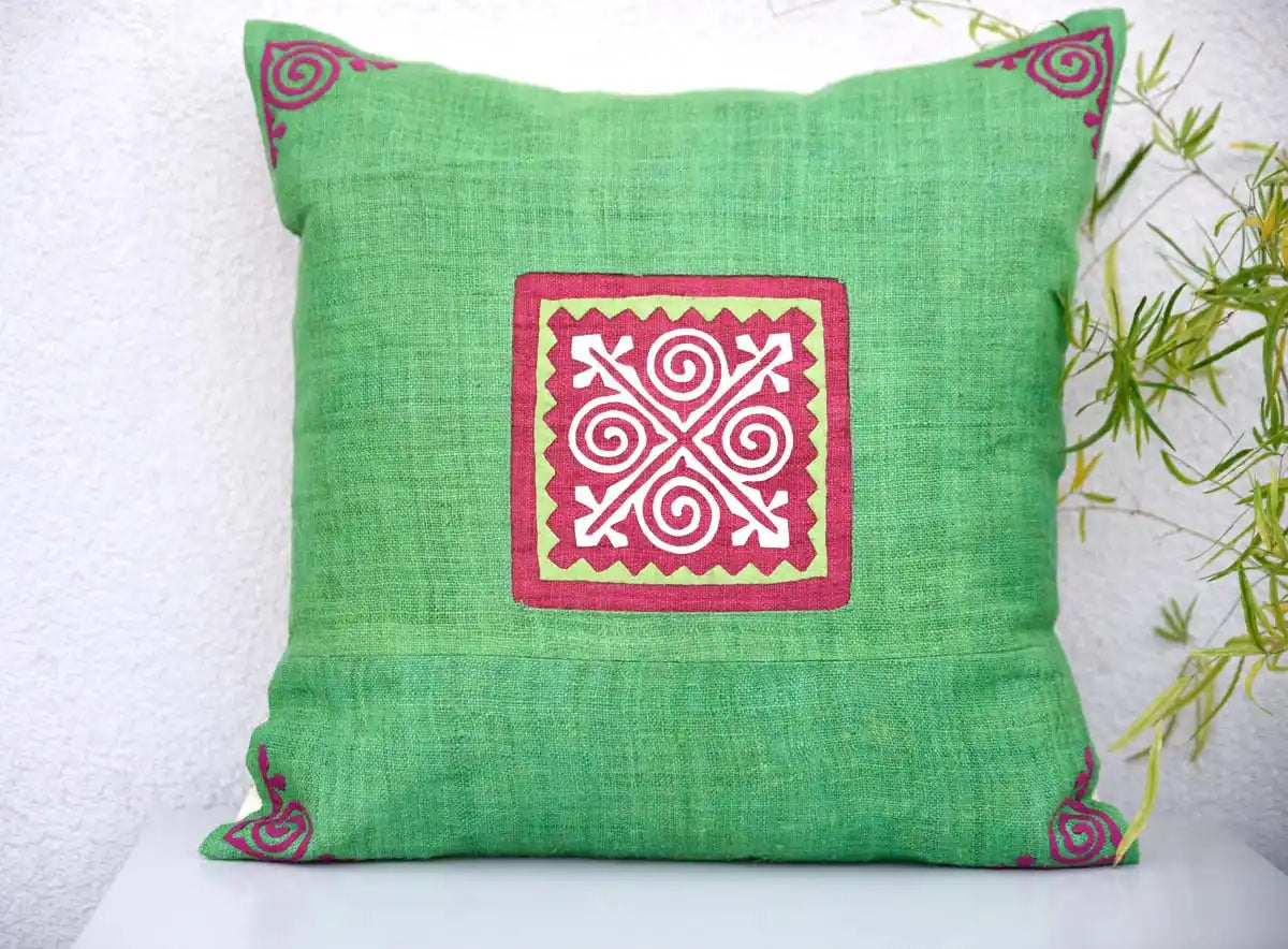 Vindigo green cushion cover with red square spiral motif centered