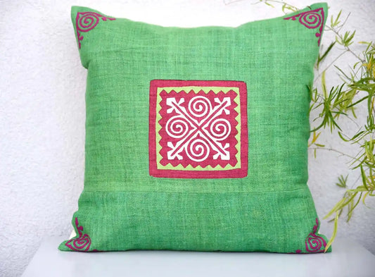 Vindigo green cushion cover with red square spiral motif centered