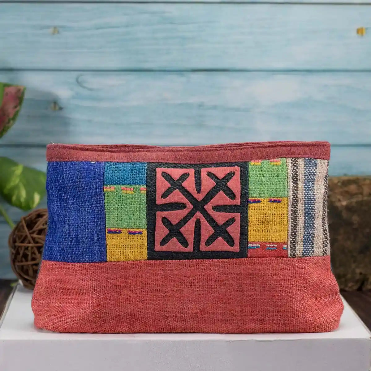 Vindigo red hemp cosmetic bag with multicolor embroidered H’mong motif front view