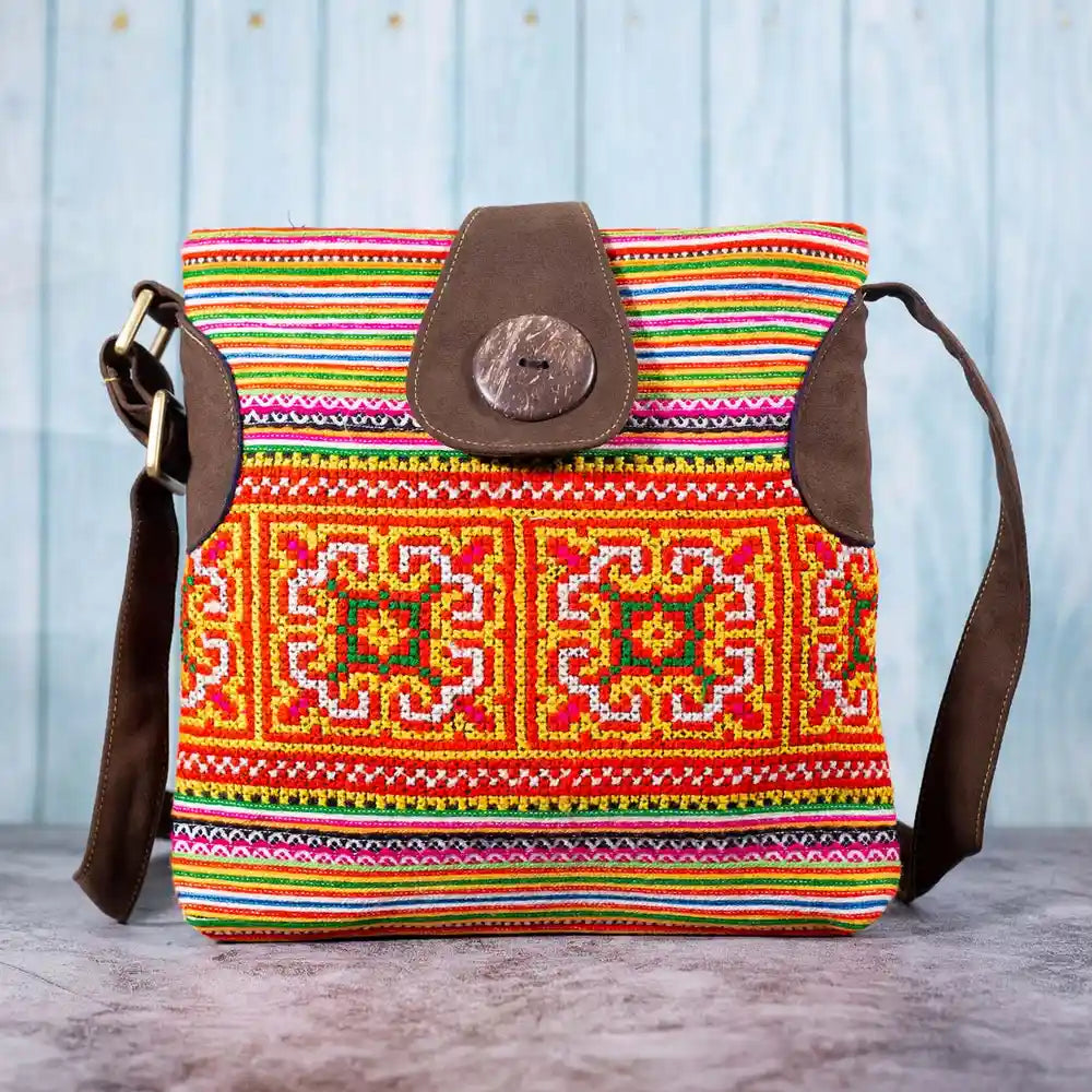 Vindigo orange hemp crossbody bag front view with H’mong embroidery and coconut button