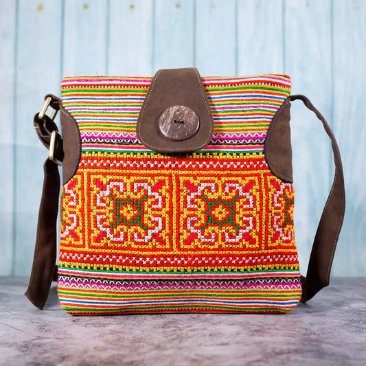 Vindigo orange hemp crossbody bag front view with H’mong embroidery and coconut button