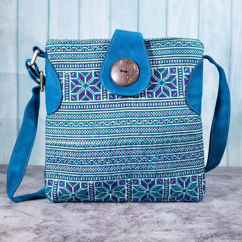 Vindigo blue embroidered crossbody bag front view with H’mong motifs and coconut button