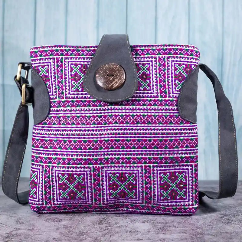 Vindigo purple embroidered crossbody bag front view with full-body H’mong patterns and coconut button