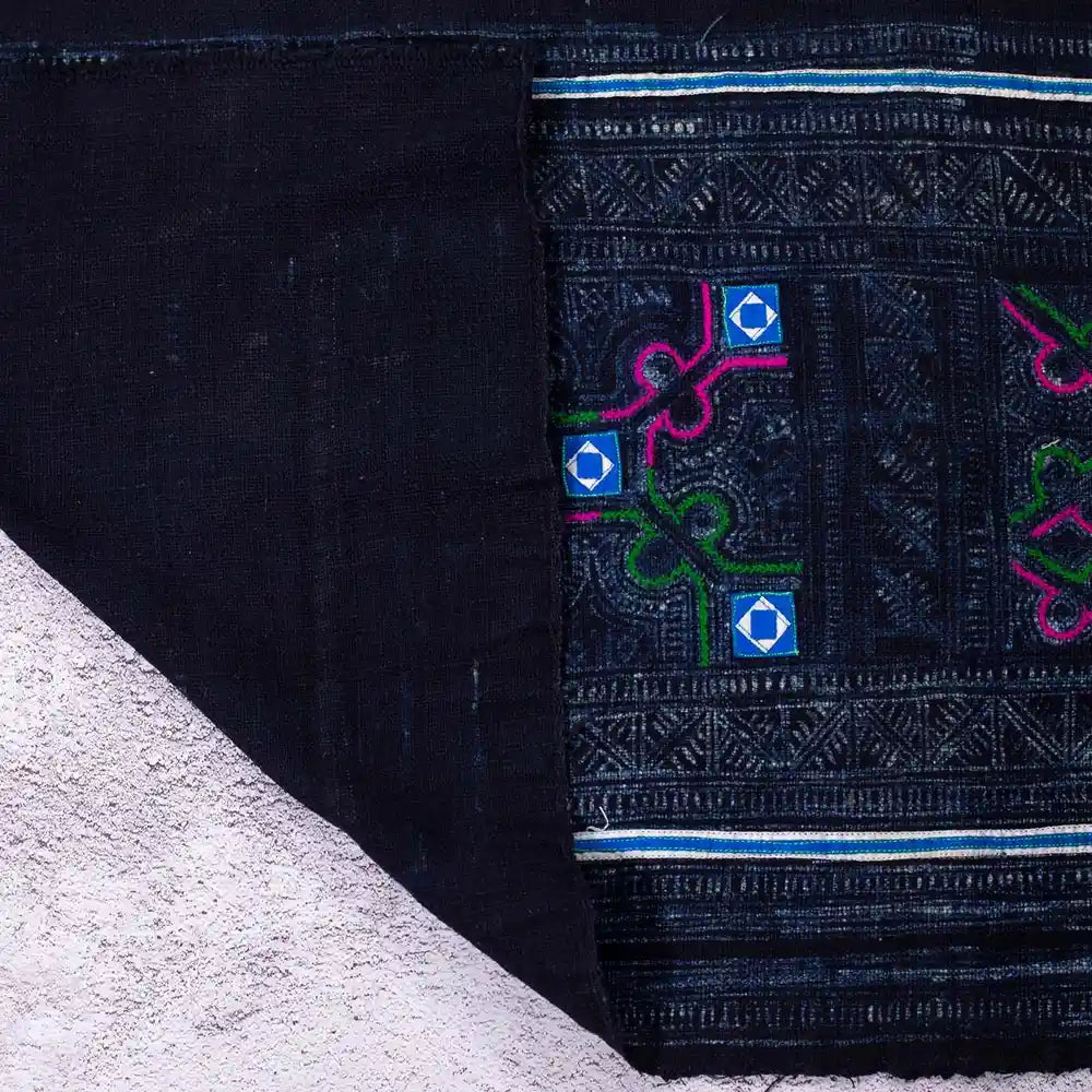 Vindigo black fabric roll with Hmong vintage embroidery, folded corner view