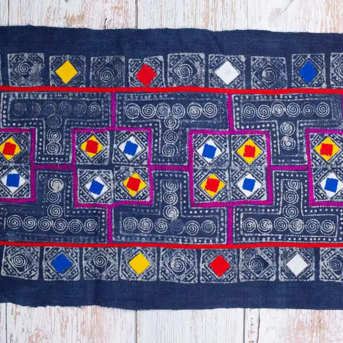 Vindigo indigo fabric roll with multicolor square embroidery, flat view