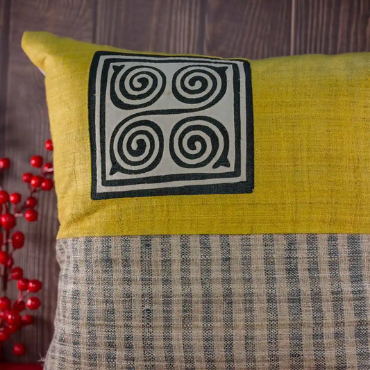 Vindigo yellow hemp cushion cover with Hmong spiral patch front view
