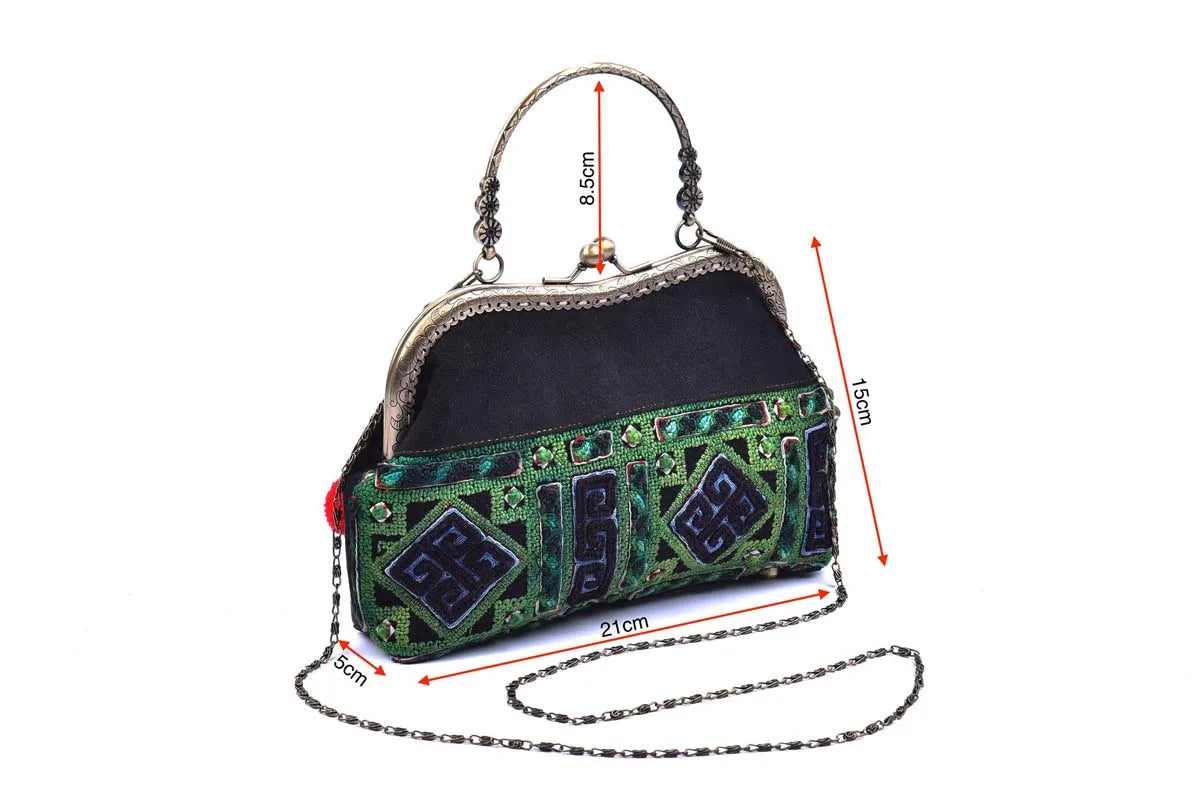 Black and green embroidered handbag with copper handle and size reference