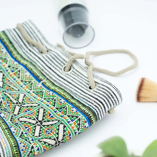 Vindigo tribal pouch with green embroidery and drawstring close-up