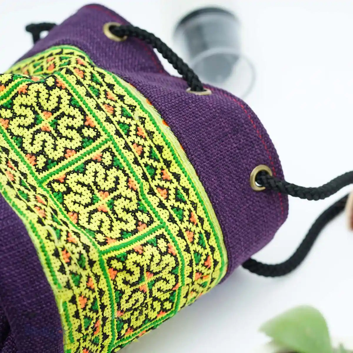 Vindigo purple tribal pouch close-up with green embroidered pattern