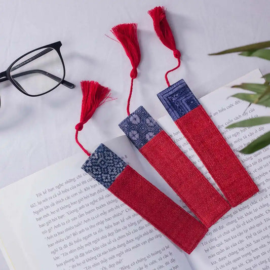 Vindigo handmade red hemp batik bookmarks arranged beside glasses
