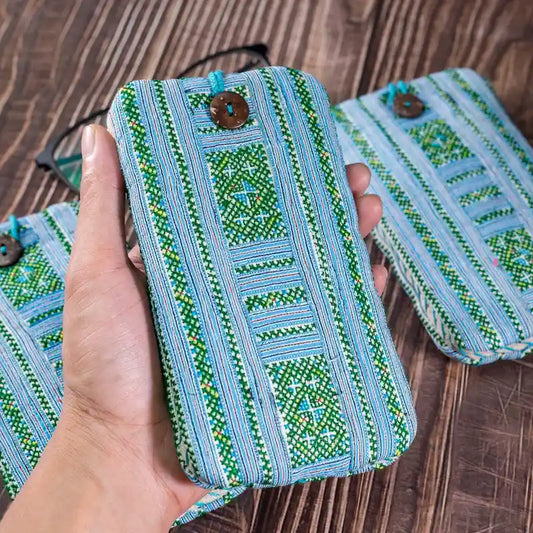 Vindigo embroidered phone case held in hand close-up