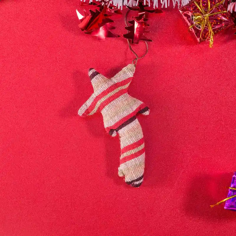 Vindigo handmade red tribal embroidered bell ornament close-up on red surface