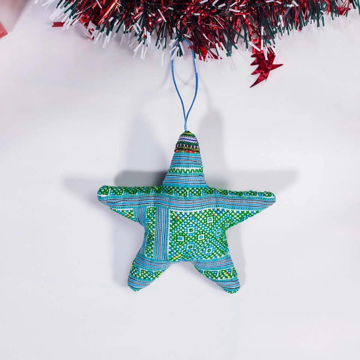 Vindigo green tribal embroidered star-shaped Christmas ornament front view