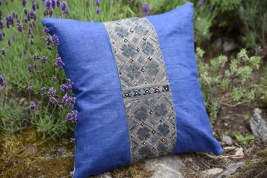 Side view of blue cushion with tribal embroidery outdoors