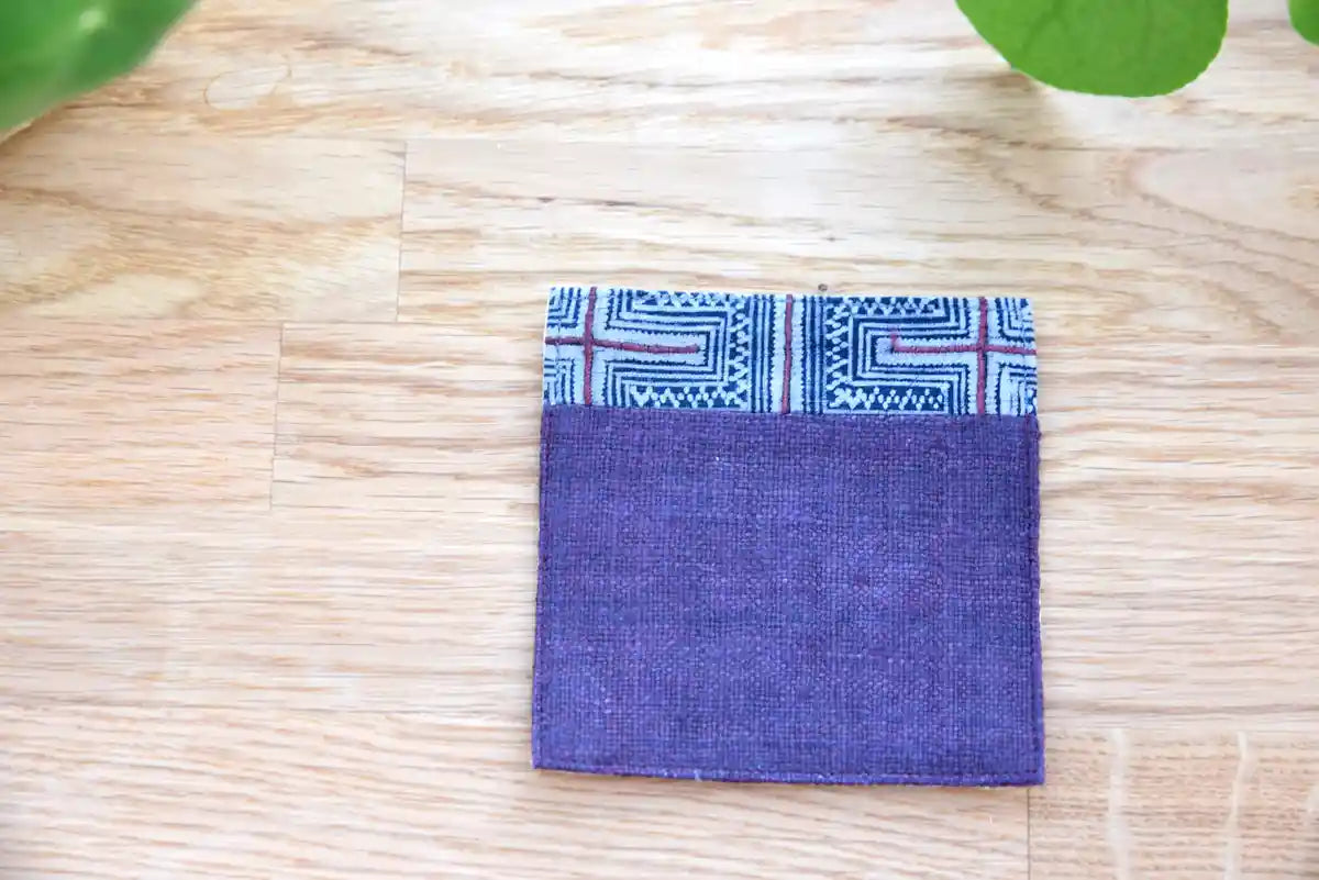 Front view of indigo hemp coaster with blue tribal fabric accent