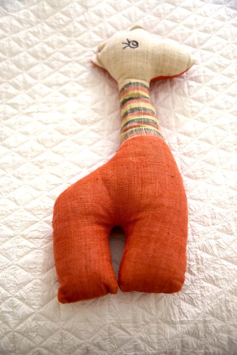 Front view of orange hemp stuffed deer with striped neck