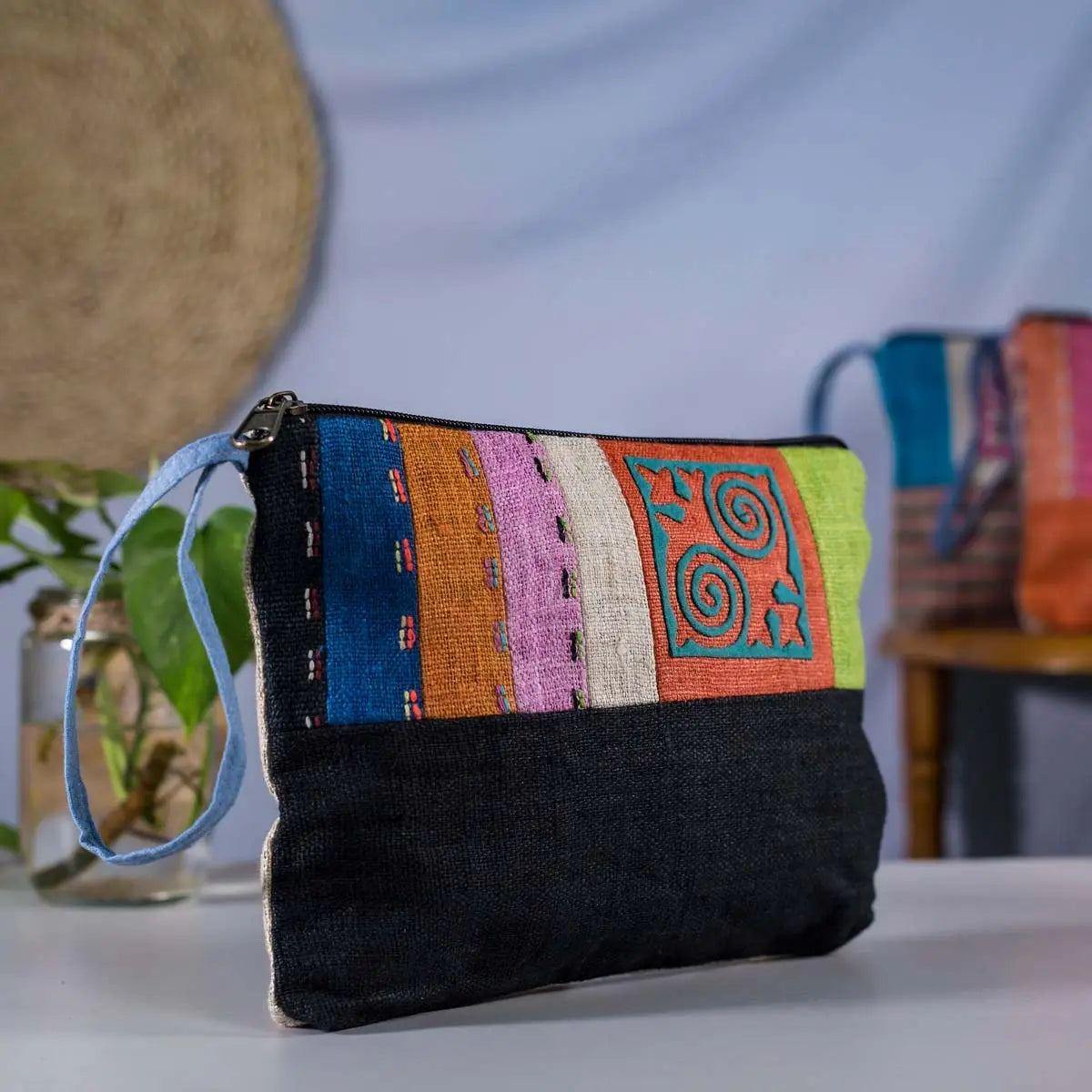 Vindigo hemp cosmetic bag front close-up showing colorful woven stripes and motifs