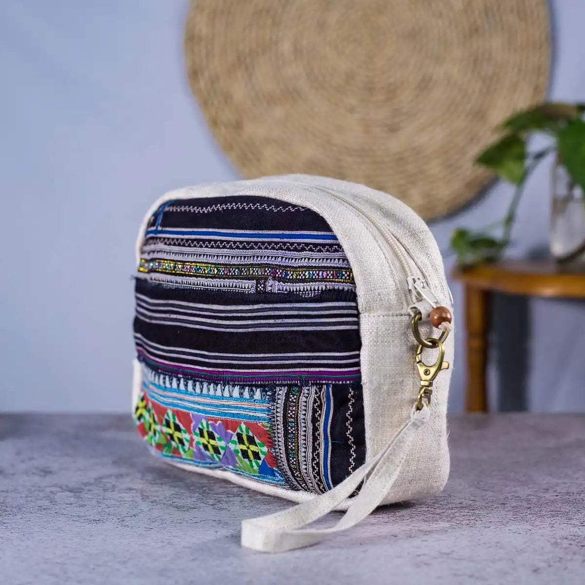 Vindigo hemp cosmetic bag front close-up showing blue woven stripes and H’mong patterns