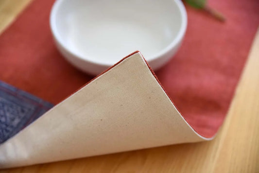Backside view of handmade hemp placemat in earthy red tone