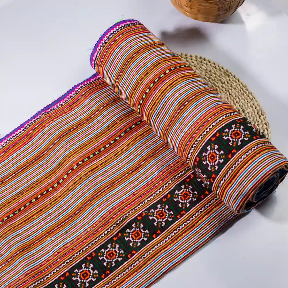 Vindigo handmade orange cotton fabric roll with black floral border side angle