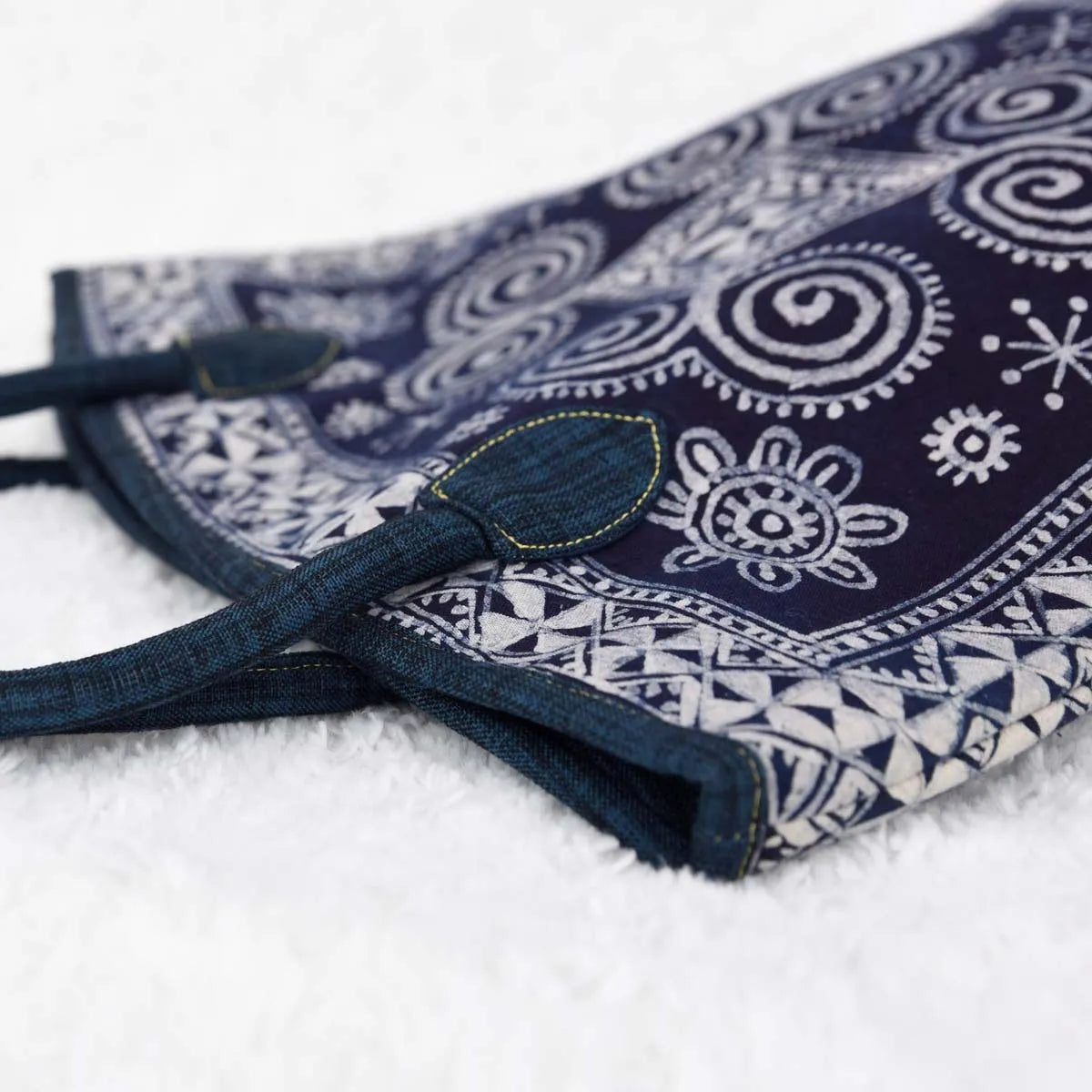 Vindigo tote side view showing floral and spiral batik