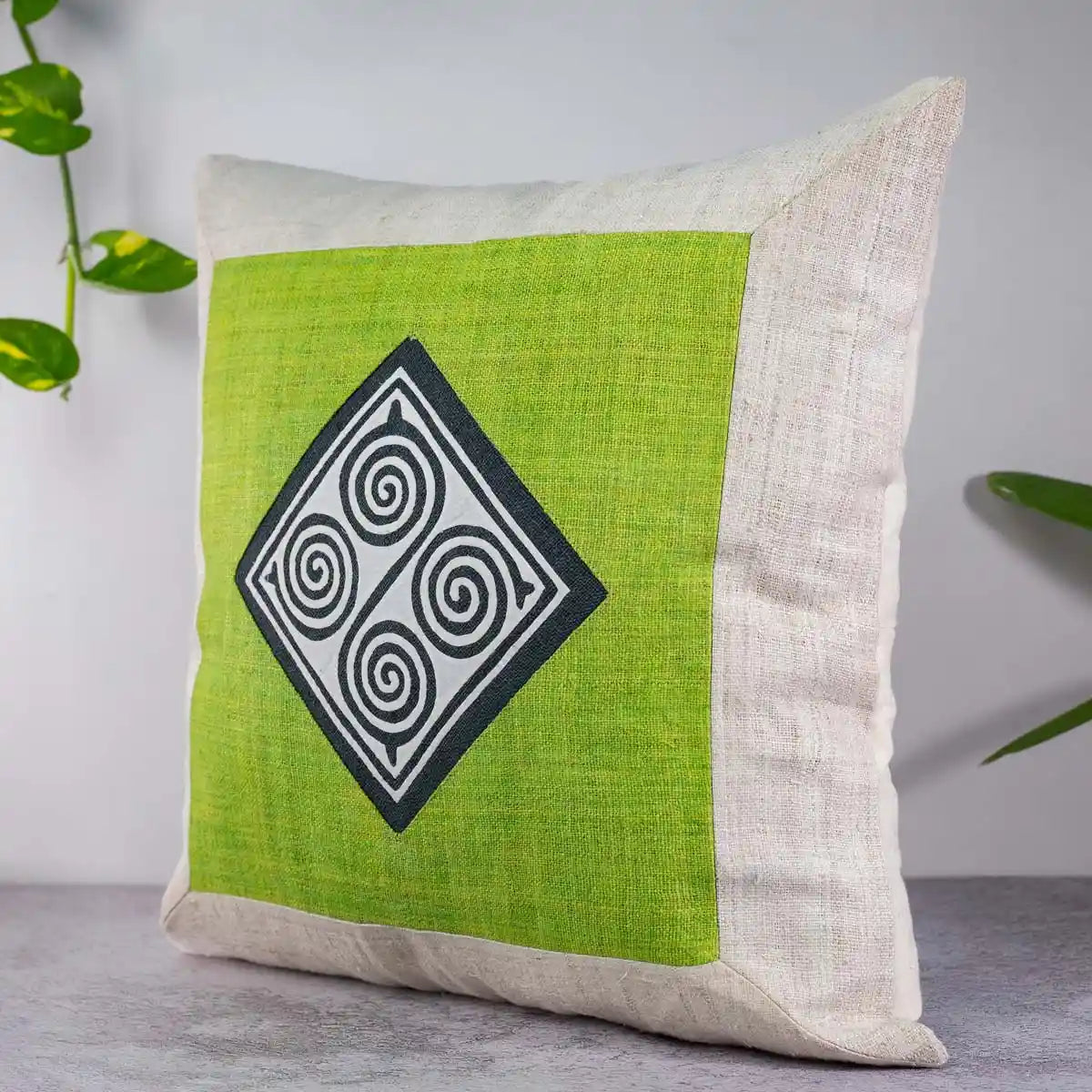 Vindigo green hemp cushion cover with spiral design styled with plant