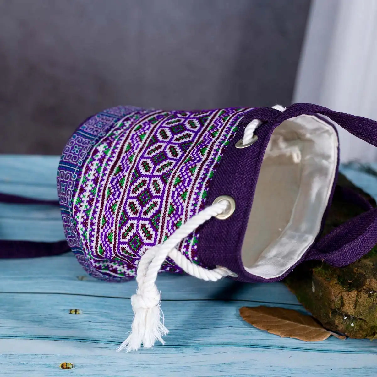 Vindigo purple embroidered canvas bucket bag lying flat detail