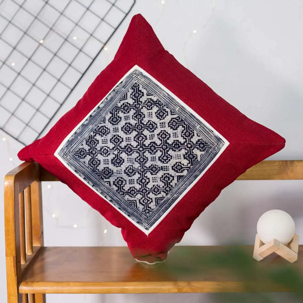 Vindigo red cushion cover angled view showing traditional H’mong batik pattern