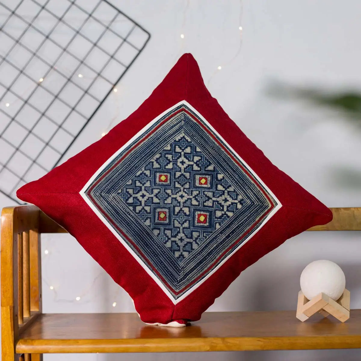 Vindigo red cushion cover angled view highlighting detailed H’mong batik embroidery