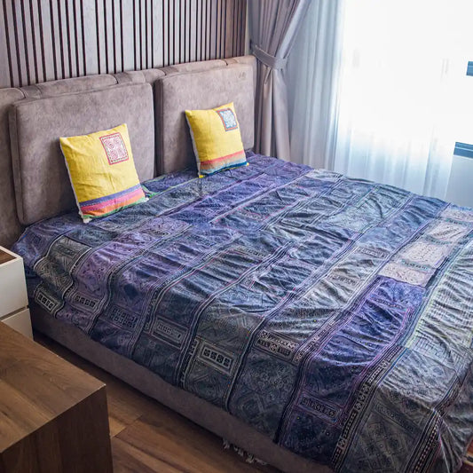 Vindigo indigo Hmong cotton bed cover on bed with yellow cushions
