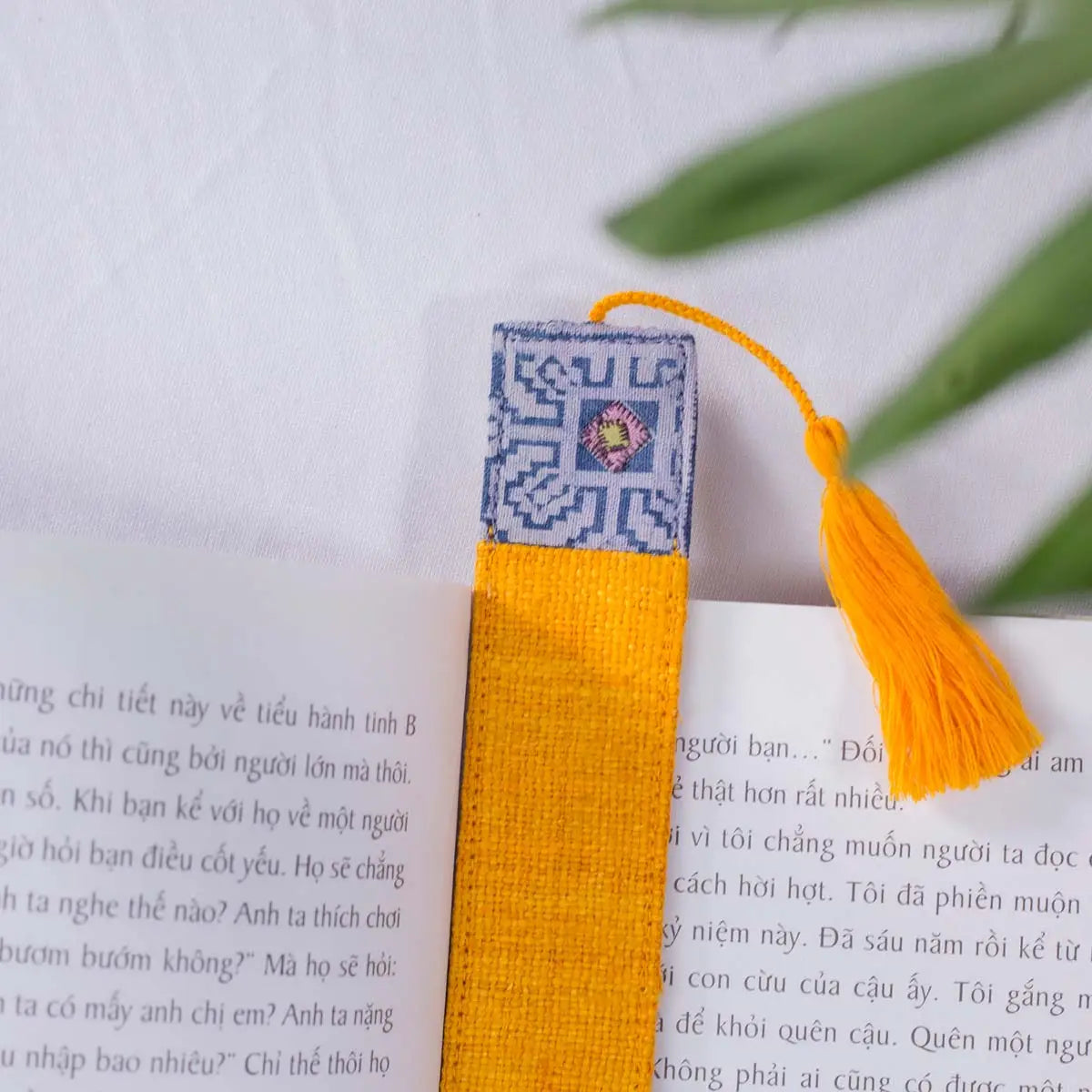 Vindigo yellow hemp embroidered bookmark side angle on book