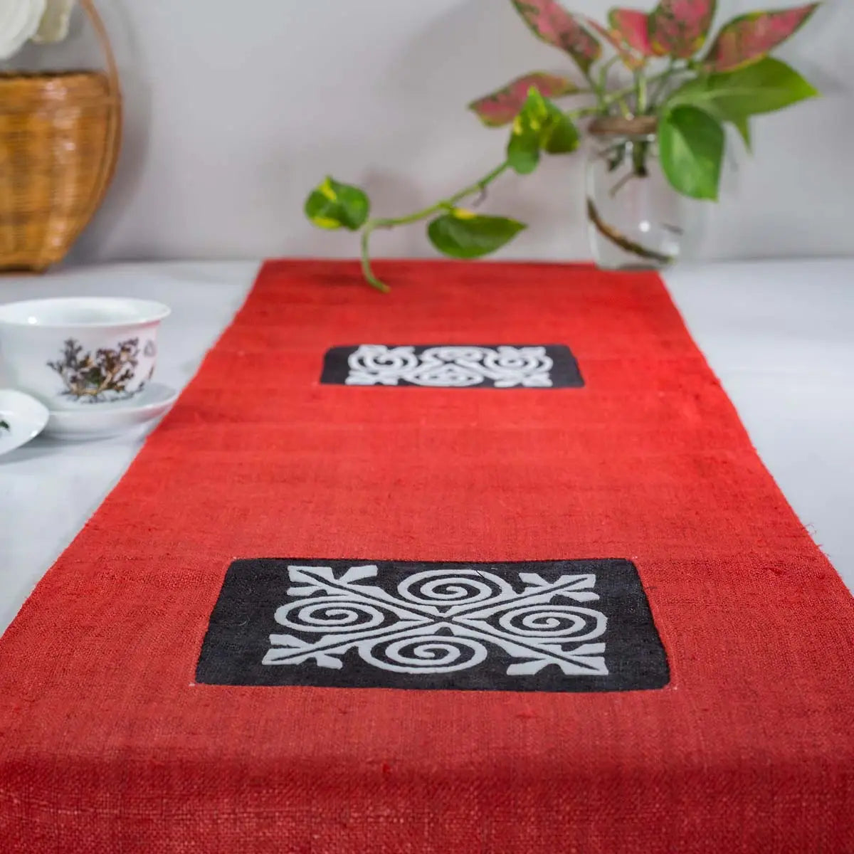 Vindigo red hemp table runner lifestyle view highlighting three main embroidered patterns