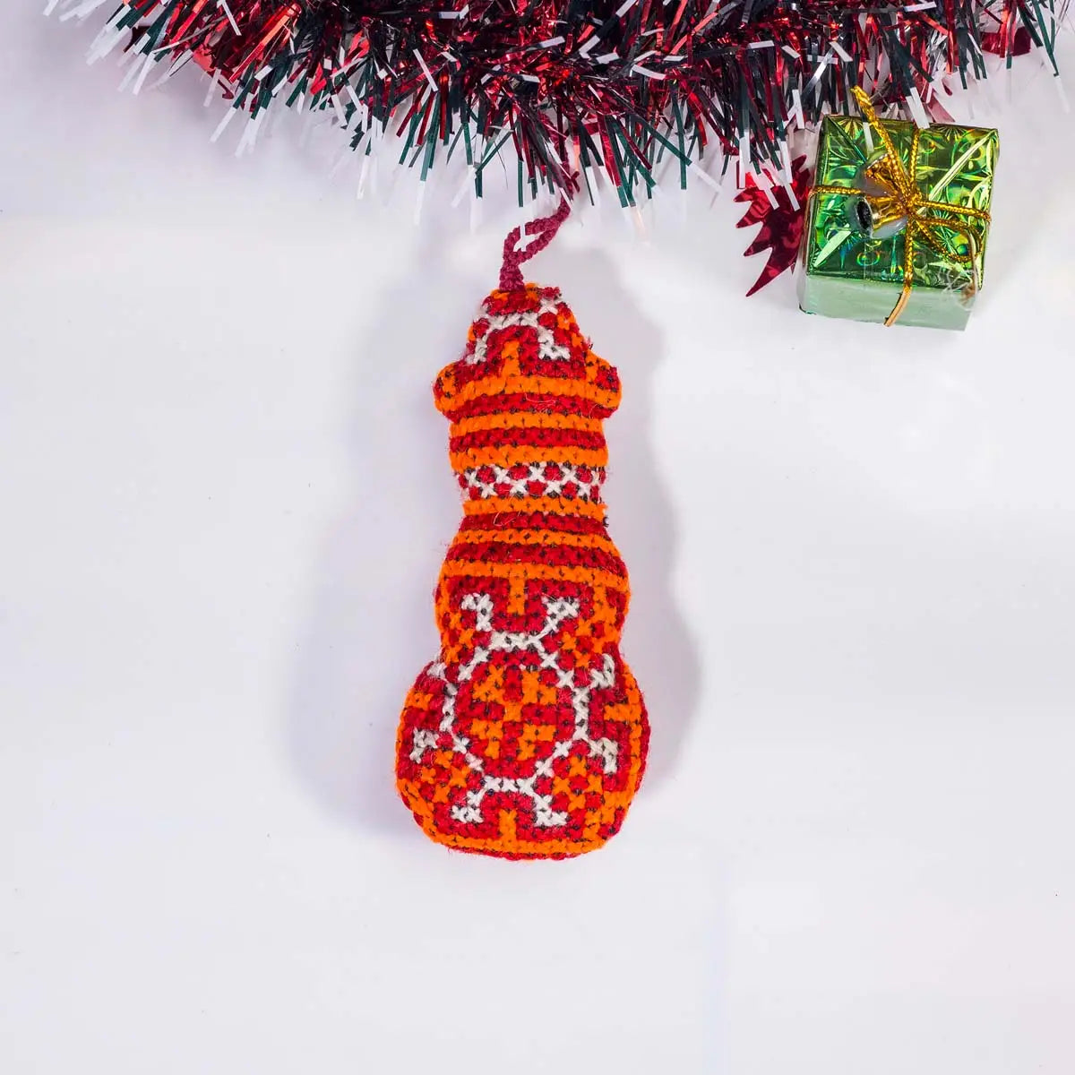 Vindigo red tribal embroidered bell-shaped Christmas ornament front view